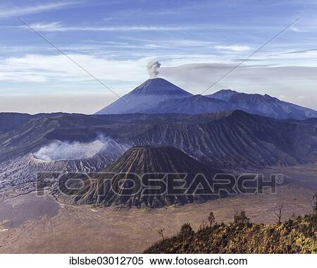 Stock Photography - "Mount Bromo with smoke, Mount Batok at front, Mt Kursi and Mt Gunung Semeru with eruption at back, volcano, eruption, Bromo Tengger Semeru National Park, Mount Bromo, Java, Indonesia, Asia". Fotosearch