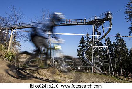 Mountain biker, bike park, downhill mountain bike trail at the Winterberg bobsleigh track, a converted ski lift is used to transport mountain bikers and their bikes up the mountain, Sauerland, North Rhine-Westphalia, Germany, Europe View Large Photo Image Stock Image - Mountain biker, bike park, downhill mountain bike trail at the Winterberg bobsleigh track, a converted ski lift is used to transport mountain bikers and their bikes up the mountain, Sauerland, North Rhine-Westphalia, Germany, Europe. Fotosearch