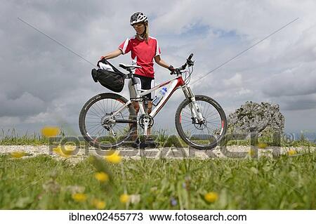 Stock Image - "Mountain biker on Kampenwand Mountain, Chiemgau, Bavaria, Germany, Europe". Fotosearch