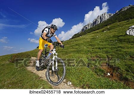 Stock Photo - "Mountain biker on Kampenwand Mountain, Chiemgau, Upper Bavaria, Bavaria, Germany, Europe". Fotosearch