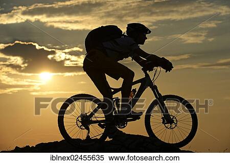 "Mountain biker on Kampenwand Mountain, silhouette against the light, Chiemgau, Upper Bavaria, Bavaria, Germany, Europe" View Large Photo Image Stock Photography - "Mountain biker on Kampenwand Mountain, silhouette against the light, Chiemgau, Upper Bavaria, Bavaria, Germany, Europe". Fotosearch