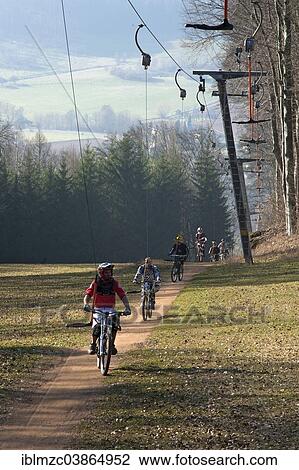"Mountain bikers are pulled by a ski lift, Osternohe, Bavaria, Germany, Europe" View Large Photo Image Stock Image - "Mountain bikers are pulled by a ski lift, Osternohe, Bavaria, Germany, Europe". Fotosearch