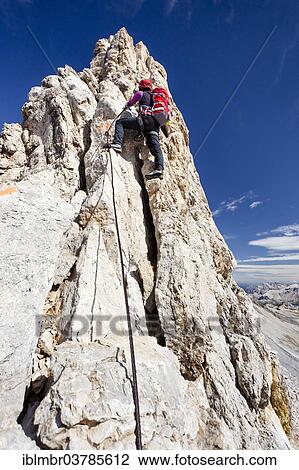 "Mountain climber ascending along the Zehner Ferrata climbing route to Zehnerspitze Mountain in the Fanes Group in Fanes-Senes-Prags Nature Park, Alta Badia, Dolomites, Alto Adige, Italy, Europe" View Large Photo Image Stock Image - "Mountain climber ascending along the Zehner Ferrata climbing route to Zehnerspitze Mountain in the Fanes Group in Fanes-Senes-Prags Nature Park, Alta Badia, Dolomites, Alto Adige, Italy, Europe". Fotosearch