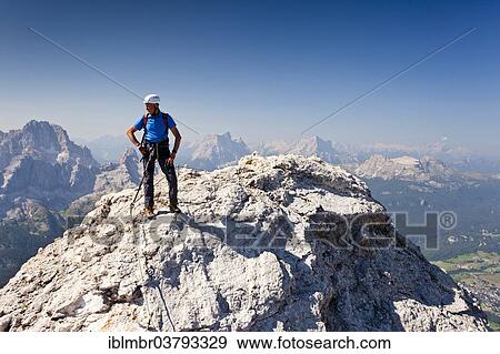 "Mountain climber ascending Cristallo di Mezzo along the Via Ferrata Marino Bianchi climbing route on Monte Cristallo above Cortina d'Ampezzo, with Pelmo Mountain at the rear, Ampezzo Dolomites, Belluno, Italy, Europe" View Large Photo Image Stock Photo - "Mountain climber ascending Cristallo di Mezzo along the Via Ferrata Marino Bianchi climbing route on Monte Cristallo above Cortina d'Ampezzo, with Pelmo Mountain at the rear, Ampezzo Dolomites, Belluno, Italy, Europe". Fotosearch