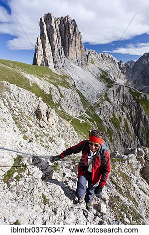 "Mountain climber ascending Croda Rossa or Sextener Rotwand in the Rosengarten Group along the Via Ferrata Croda Rossa climbing route, view over Vaiolon Pass towards Tscheinerspitze Mountain, Dolomites, Alto Adige, Italy, Europe" View Large Photo Image Stock Photo - "Mountain climber ascending Croda Rossa or Sextener Rotwand in the Rosengarten Group along the Via Ferrata Croda Rossa climbing route, view over Vaiolon Pass towards Tscheinerspitze Mountain, Dolomites, Alto Adige, Italy, Europe". Fotosearch