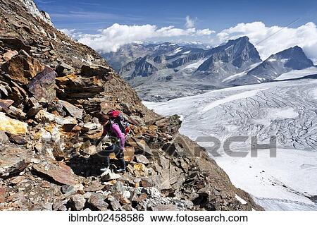 "Mountain climber ascending Schneebiger Nock Mountain, looking towards Hochgall Mountain, Alto Adige, Italy, Europe" View Large Photo Image Stock Photograph - "Mountain climber ascending Schneebiger Nock Mountain, looking towards Hochgall Mountain, Alto Adige, Italy, Europe". Fotosearch