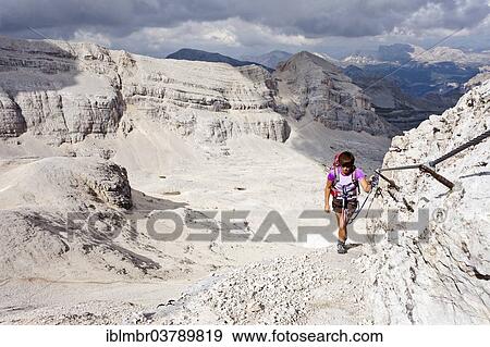 Stock Photo - "Mountain climber ascending Cunturines-Spitze Mountain in Fanes-Senes-Prague Nature Park, Val Badia, Dolomites, Alto Adige, Italy, Europe". Fotosearch
