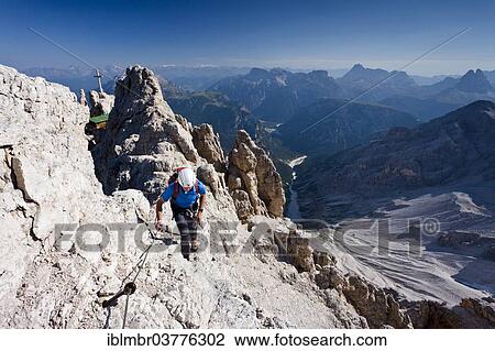 "Mountain climber ascending the Via Ferrata Marino Bianchi climbing route on Cristallo di Mezzo Mountain, Dolomites, Belluno, Italy, Europe" View Large Photo Image Stock Image - "Mountain climber ascending the Via Ferrata Marino Bianchi climbing route on Cristallo di Mezzo Mountain, Dolomites, Belluno, Italy, Europe". Fotosearch