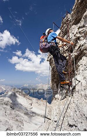 "Mountain climber ascending the Via Ferrata Ivano Dibona climbing route on Monte Cristallo, Belluno province, Italy, Europe" View Large Photo Image Stock Photograph - "Mountain climber ascending the Via Ferrata Ivano Dibona climbing route on Monte Cristallo, Belluno province, Italy, Europe". Fotosearch
