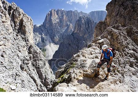 Stock Photo - "Mountain climber ascending to the summit of Sasso Piatto Mountain via the Oskar Schuster climbing route, Sasso Lungo Mountain at the rear, Dolomites, oberhalb der Langkofelhutte, Plattkofel, South Tyrol province, Trentino-Alto Adige, Italy, Europe". Fotosearch