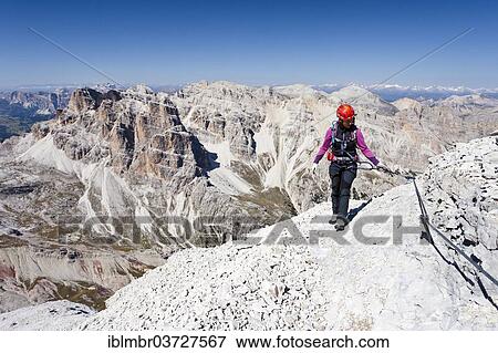 "Mountain climber ascending Tofane di Rozes Mountain along the Via Ferrata Giovanni Lipella climbing route, Dolomites, Belluno province, Italy, Europe" View Large Photo Image Stock Photo - "Mountain climber ascending Tofane di Rozes Mountain along the Via Ferrata Giovanni Lipella climbing route, Dolomites, Belluno province, Italy, Europe". Fotosearch