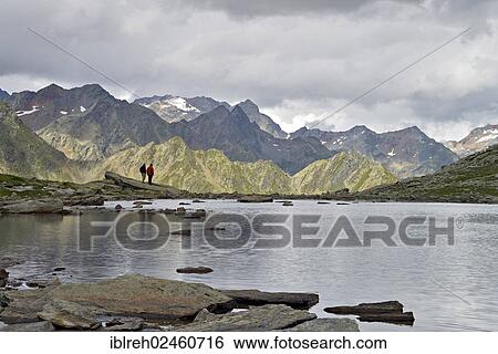 "Mountain climber at a mountain lake at Timmelsjoch, looking towards the Stubai Alps, Timmelstal, Tyrol, Austria, Europe" View Large Photo Image Stock Photograph - "Mountain climber at a mountain lake at Timmelsjoch, looking towards the Stubai Alps, Timmelstal, Tyrol, Austria, Europe". Fotosearch