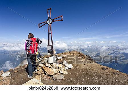 "Mountain climber at the summit cross on Schneebiger Nock Mountain in the Rieserferner Group, Alto Adige, Italy, Europe" View Large Photo Image Stock Photo - "Mountain climber at the summit cross on Schneebiger Nock Mountain in the Rieserferner Group, Alto Adige, Italy, Europe". Fotosearch