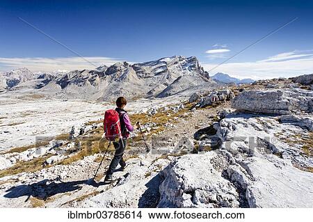 Picture - "Mountain climber descending along the Heiligkreuzkofelsteig climbing route from Heiligkreuzkofel Mountain in the Fanes Group in the Fanes-Senes-Prags Nature Park, in front of Piz de Lavarela Mountain, Alta Badia, Dolomites, Alto Adige, Italy, Europe". Fotosearch