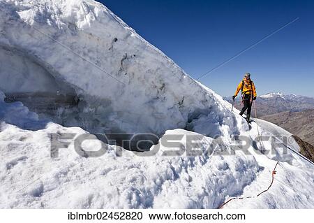 Stock Image - "Mountain climber descending from Monte Cevedale, here at the margin, Alto Adige, Italy, Europe". Fotosearch
