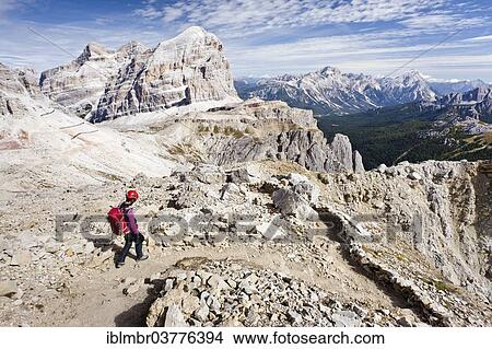Picture - "Mountain climber descending from Lagazuoi Mountain in the Fanes Group, overlooking the Tofane Mountains with Tofana di Rozes, Tofana di Mezzo, Tofana di Dentro, Dolomites, Belluno, Italy, Europe". Fotosearch