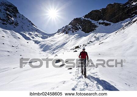 Stock Photography - "Mountain climber descending from Wilde Kreuzspitze Mountain in the Pfunderer Mountains, with Rauhtaljoch Pass at the rear, Alto Adige, Italy, Europe". Fotosearch