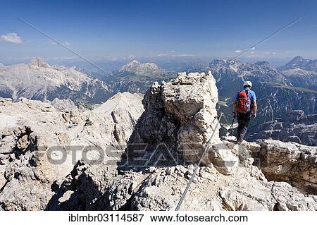 "Mountain climber descending the Marino Bianchi climbing route on Monte Cristallo to the summit of Cristallo di Mezzo, Hohe Gaisl Mountain at the rear, via ferrata, Dolomites, oberhalb von Cortina d'Ampezzo, Province of Belluno, Veneto, Italy, Europe" View Large Photo Image Stock Photo - "Mountain climber descending the Marino Bianchi climbing route on Monte Cristallo to the summit of Cristallo di Mezzo, Hohe Gaisl Mountain at the rear, via ferrata, Dolomites, oberhalb von Cortina d'Ampezzo, Province of Belluno, Veneto, Italy, Europe". Fotosearch