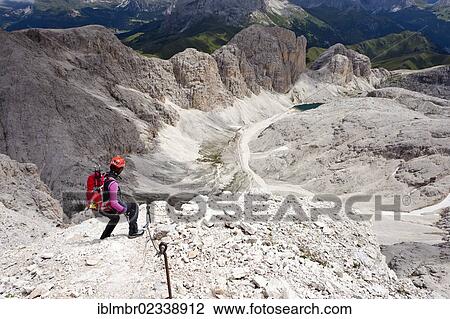 "Mountain climber during the descent from Kesselkogel Mountain via a climbing route in the Rosengarten Group, looking towards Lake Antermoia, Trentino, Italy, Europe" View Large Photo Image Stock Image - "Mountain climber during the descent from Kesselkogel Mountain via a climbing route in the Rosengarten Group, looking towards Lake Antermoia, Trentino, Italy, Europe". Fotosearch