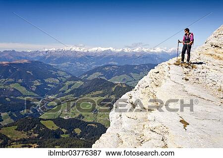 Stock Photo - "Mountain climber on Kreuzkofelscharte while ascending the Heiligkreuzkofelsteig climbing route on Heiligkreuzkofel Mountain in the Fanes Group, in Fanes-Sennes-Prags Nature Park, overlooking Val Badia valley, Dolomites, Alto Adige, Italy, Europe". Fotosearch