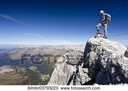 Stock Image - "Mountain climber on the summit of Cima di Vezzana Mountain, Pala Group, Trentino Province, Italy, Europe". Fotosearch