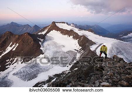 "Mountain climber standing at the summit of Wilder Pfaff Mountain looking towards Alto Adige, mountain ridge forming the border between Austria and Italy, Stubai Valley, Stubai Alps, Tyrol, Austria, Europe" View Large Photo Image Stock Photo - "Mountain climber standing at the summit of Wilder Pfaff Mountain looking towards Alto Adige, mountain ridge forming the border between Austria and Italy, Stubai Valley, Stubai Alps, Tyrol, Austria, Europe". Fotosearch