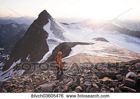 "Mountain climber standing at the summit of Wilder Pfaff Mountain and looking towards the sunset, Stubai Alps, left in the foreground is Zuckerhuetl Mountain, Stubai Valley, Stubai Alps, Tyrol, Austria, Europe" View Large Photo Image Stock Photograph - "Mountain climber standing at the summit of Wilder Pfaff Mountain and looking towards the sunset, Stubai Alps, left in the foreground is Zuckerhuetl Mountain, Stubai Valley, Stubai Alps, Tyrol, Austria, Europe". Fotosearch