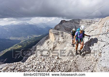 "Mountain climbers ascending Cunturines-Spitze Mountain, with Piz de Lavarela Mountain at the rear, overlooking Val Badia, Fanes-Sennes-Prags Nature Park, Dolomites, Alto Adige, Italy, Europe" View Large Photo Image Picture - "Mountain climbers ascending Cunturines-Spitze Mountain, with Piz de Lavarela Mountain at the rear, overlooking Val Badia, Fanes-Sennes-Prags Nature Park, Dolomites, Alto Adige, Italy, Europe". Fotosearch
