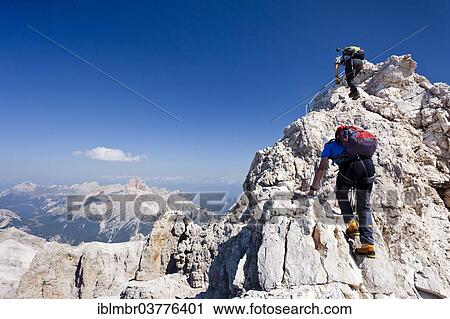 "Mountain climbers climbing on the Via Ferrata Marino Bianchi climbing route on Monte Cristallo, with Croda Rossa Mountain in the distance, Dolomites, Belluno, Italy, Europe" View Large Photo Image Stock Image - "Mountain climbers climbing on the Via Ferrata Marino Bianchi climbing route on Monte Cristallo, with Croda Rossa Mountain in the distance, Dolomites, Belluno, Italy, Europe". Fotosearch