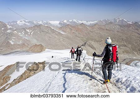 "Mountain climbers descending from Similaun Mountain along the summit ridge of Niederjochferner Glacier in Schnalstal valley, looking towards Marzellkamm Ridge, Province of Alto Adige, Italy, Europe" View Large Photo Image Stock Image - "Mountain climbers descending from Similaun Mountain along the summit ridge of Niederjochferner Glacier in Schnalstal valley, looking towards Marzellkamm Ridge, Province of Alto Adige, Italy, Europe". Fotosearch