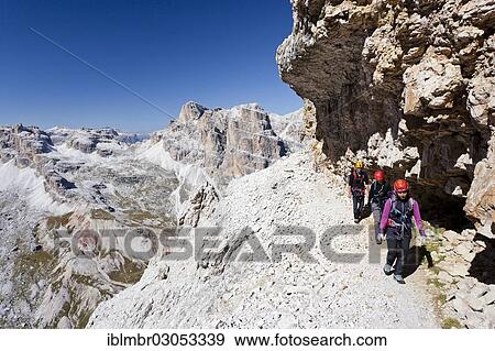 "Mountain climbers during the ascent of Mt Tofana di Roze on the Via Ferrata Giovanni Lipella, Sella Massif at back, Dolomites, Alpen, Province of Belluno, Veneto, Italy, Europe" View Large Photo Image Stock Photo - "Mountain climbers during the ascent of Mt Tofana di Roze on the Via Ferrata Giovanni Lipella, Sella Massif at back, Dolomites, Alpen, Province of Belluno, Veneto, Italy, Europe". Fotosearch