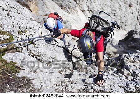 Picture - "Mountain climbers during the ascent to the summit of Plattkofel Mountain via the Oskar Schuster Via Ferrata climbing route, Dolomites, Alto Adige, Italy, Europe". Fotosearch