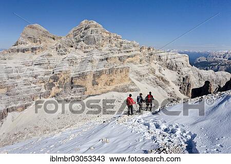 Stock Image - "Mountain climbers during the descent from Mt Tofana di Roze, Mt Tofana di Mezzo and Mt Tofana di Dentro at back, Dolomites, Alpen, Province of Belluno, Veneto, Italy, Europe". Fotosearch