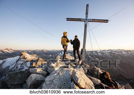 "Mountain climbers on the summit cross of Reichenspitze Mountain, 3303m, Zillertal Alps, High Tauern National Park, Austria, Europe" View Large Photo Image Stock Photograph - "Mountain climbers on the summit cross of Reichenspitze Mountain, 3303m, Zillertal Alps, High Tauern National Park, Austria, Europe". Fotosearch