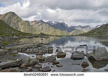 "Mountain lake at Timmelsjoch looking towards the Stubai Alps, Timmelstal, Tyrol, Austria, Europe" View Large Photo Image Stock Image - "Mountain lake at Timmelsjoch looking towards the Stubai Alps, Timmelstal, Tyrol, Austria, Europe". Fotosearch