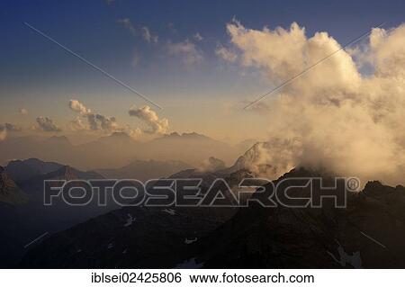 "Mountain panorama in the evening light with clouds in the sky, Warth, Vorarlberg, Austria, Europe" View Large Photo Image Stock Photograph - "Mountain panorama in the evening light with clouds in the sky, Warth, Vorarlberg, Austria, Europe". Fotosearch