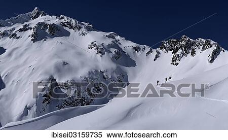 Stock Photography - "Mountain peak with ski mountaineers, Kaltenberg, St. Anton, Vorarlberg, Austria, Europe". Fotosearch