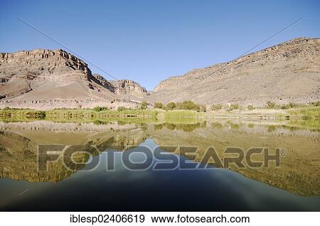 Stock Photo - "Mountain range on the South African bank of the Oranje, Orange River, border river between Namibia and South Africa". Fotosearch