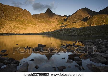 "Mountain range reflected in a small lake, Kappl, Verwall mountains, Paznauntal, Tyrol, Austria, Europe" View Large Photo Image Stock Image - "Mountain range reflected in a small lake, Kappl, Verwall mountains, Paznauntal, Tyrol, Austria, Europe". Fotosearch