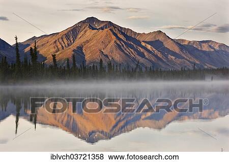 "Mountain range reflected in Drashner Lake with morning fog, Denali High Way, Alaska, USA" View Large Photo Image Stock Photo - "Mountain range reflected in Drashner Lake with morning fog, Denali High Way, Alaska, USA". Fotosearch