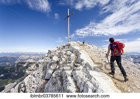"Mountaineer at the summit cross of Mt Heiligkreuzkofel of the Fanes Group in the Fanes-Sennes-Prags Nature Park, Val Badia below, Alta Badia, Dolomites, South Tyrol, Trentino-Alto Adige, Italy, Europe" View Large Photo Image Stock Image - "Mountaineer at the summit cross of Mt Heiligkreuzkofel of the Fanes Group in the Fanes-Sennes-Prags Nature Park, Val Badia below, Alta Badia, Dolomites, South Tyrol, Trentino-Alto Adige, Italy, Europe". Fotosearch