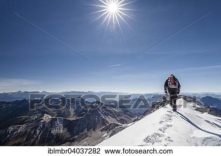 Stock Image - "Mountaineer descending via the summit ridge from Mt Hoher Weisszint, Zillertal Alps, Lappach Muhlwaldertal valley, Tauferer Ahrntal Valley, Puster Valley, South Tyrol, Italy, Finkenberg, Tyrol, Austria, Europe". Fotosearch