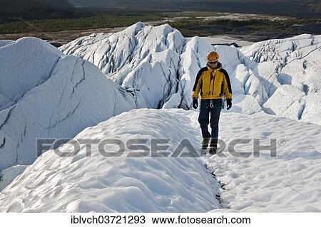 Stock Image - "Mountaineer hiking along Matanuska Glacier, Matanuska Glacier, Alaska, United States, North America". Fotosearch