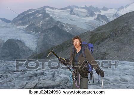 Stock Image - Mountaineer, ice axe, glacier ascent, climbing Mt Grossvenediger, Obersulzbachkees Glacier near Neukirchen am Grossvenediger, Venediger Group, Hohe Tauern or High Tauern Range, Alps, State of Salzburg, Austria, Europe. Fotosearch