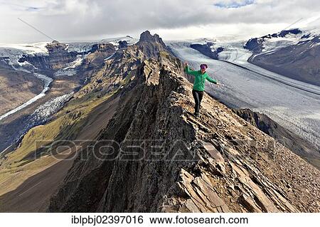 "Mountaineer on the summit ridge in front of a glacier tongue, Vatnajoekull, Skaftafell, South Iceland, Iceland, Europe" View Large Photo Image Stock Photograph - "Mountaineer on the summit ridge in front of a glacier tongue, Vatnajoekull, Skaftafell, South Iceland, Iceland, Europe". Fotosearch