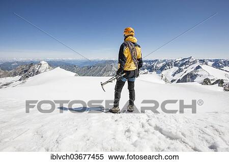 "Mountaineer standing on the summit of Mt Schwarzenstein, looking towards South Tyrol, Tyrol, Austria, Europe" View Large Photo Image Stock Photography - "Mountaineer standing on the summit of Mt Schwarzenstein, looking towards South Tyrol, Tyrol, Austria, Europe". Fotosearch