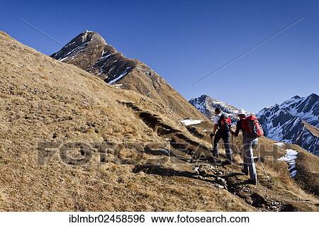 Stock Photograph - "Mountaineers climbing Wilde Kreuzspitze Mountain in the Pfunderer Mountains, currently below Wilden Lake, looking towards Blickenspitz Mountain, Dolomites, Italy, Europe". Fotosearch
