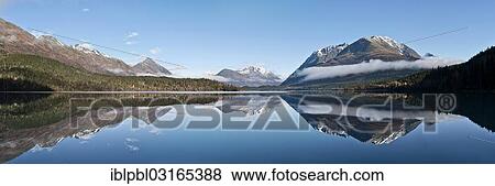 "Mountains reflecting in Trail Lake, Anchorage, Alaska, United States, North America" View Large Photo Image Stock Photo - "Mountains reflecting in Trail Lake, Anchorage, Alaska, United States, North America". Fotosearch