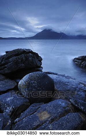 "Mountains shrouded with clouds, blue hour on a rocky seashore, Elgol, Isle of Skye, Scotland, United Kingdom, Europe" View Large Photo Image Stock Image - "Mountains shrouded with clouds, blue hour on a rocky seashore, Elgol, Isle of Skye, Scotland, United Kingdom, Europe". Fotosearch