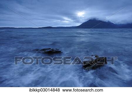 "Mountains shrouded with clouds, blue hour on a rocky seashore, Elgol, Isle of Skye, Scotland, United Kingdom, Europe" View Large Photo Image Stock Photo - "Mountains shrouded with clouds, blue hour on a rocky seashore, Elgol, Isle of Skye, Scotland, United Kingdom, Europe". Fotosearch